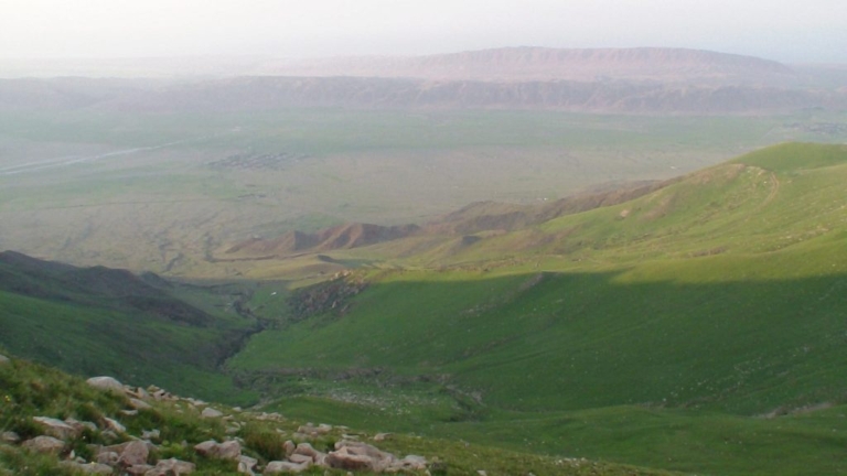A misty green mountain valley in Central Asia.