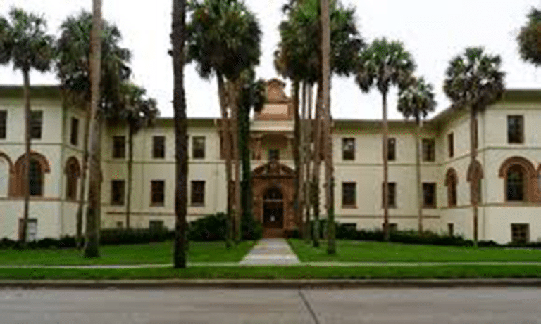 The main building of Stetson University in Florida, framed by palm trees.