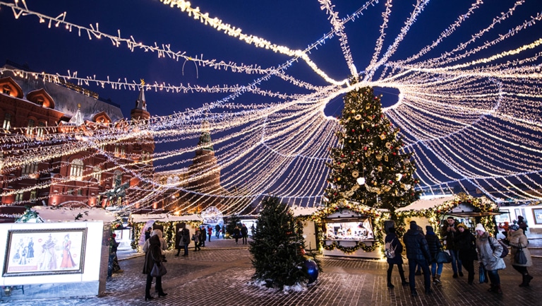 Christmas lights and a decorated tree at a holiday market near Red Square in Moscow.