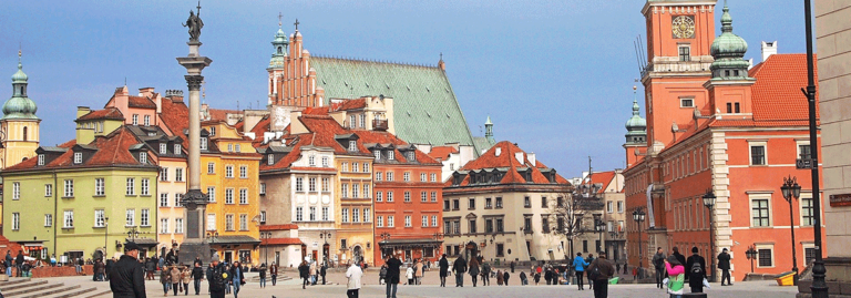 The colorful historic buildings and Sigismund's Column in Warsaw's Old Town Square.