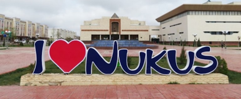An "I Love Nukus" sign in front of the Savitsky Museum building in Uzbekistan.