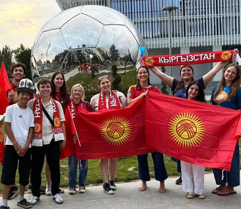 Students attend a local soccer match with local peers.