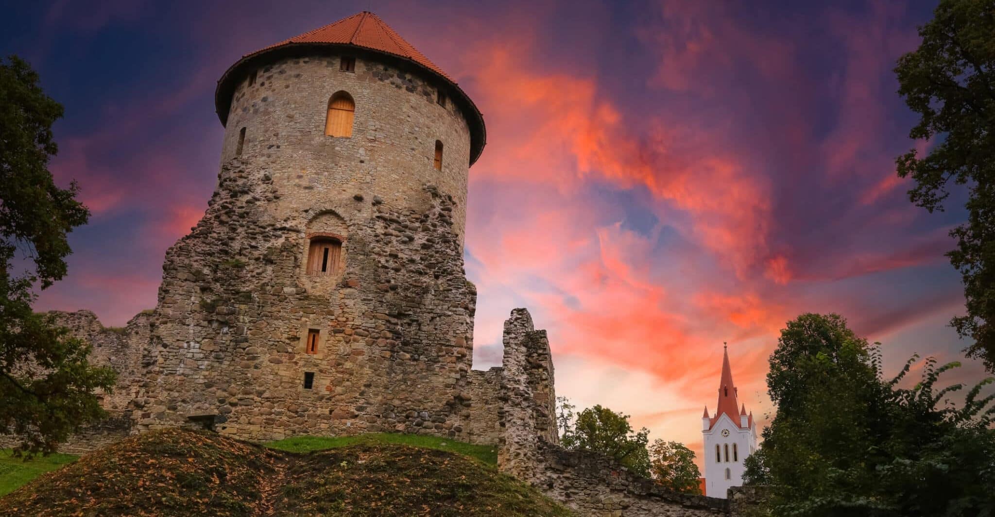 The Cesis Castle in Autumn with the medieval town center behind it.