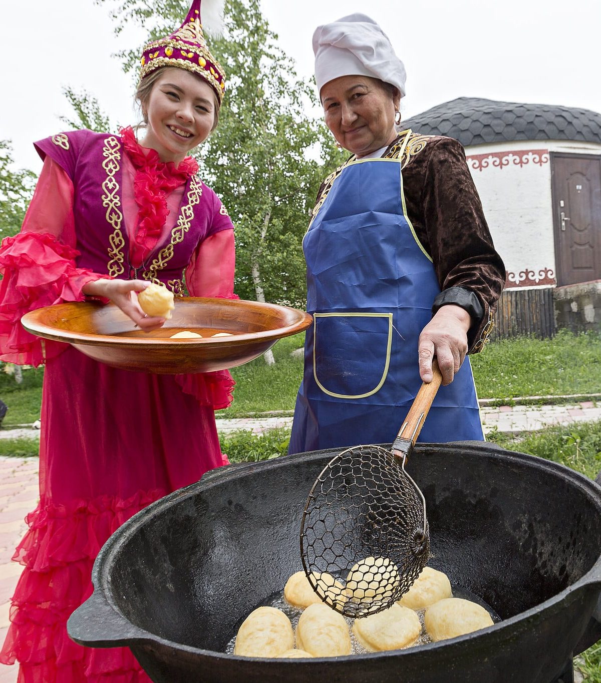 Making traditional baursak donuts in Kazakhstan, a symbol of hospitality.