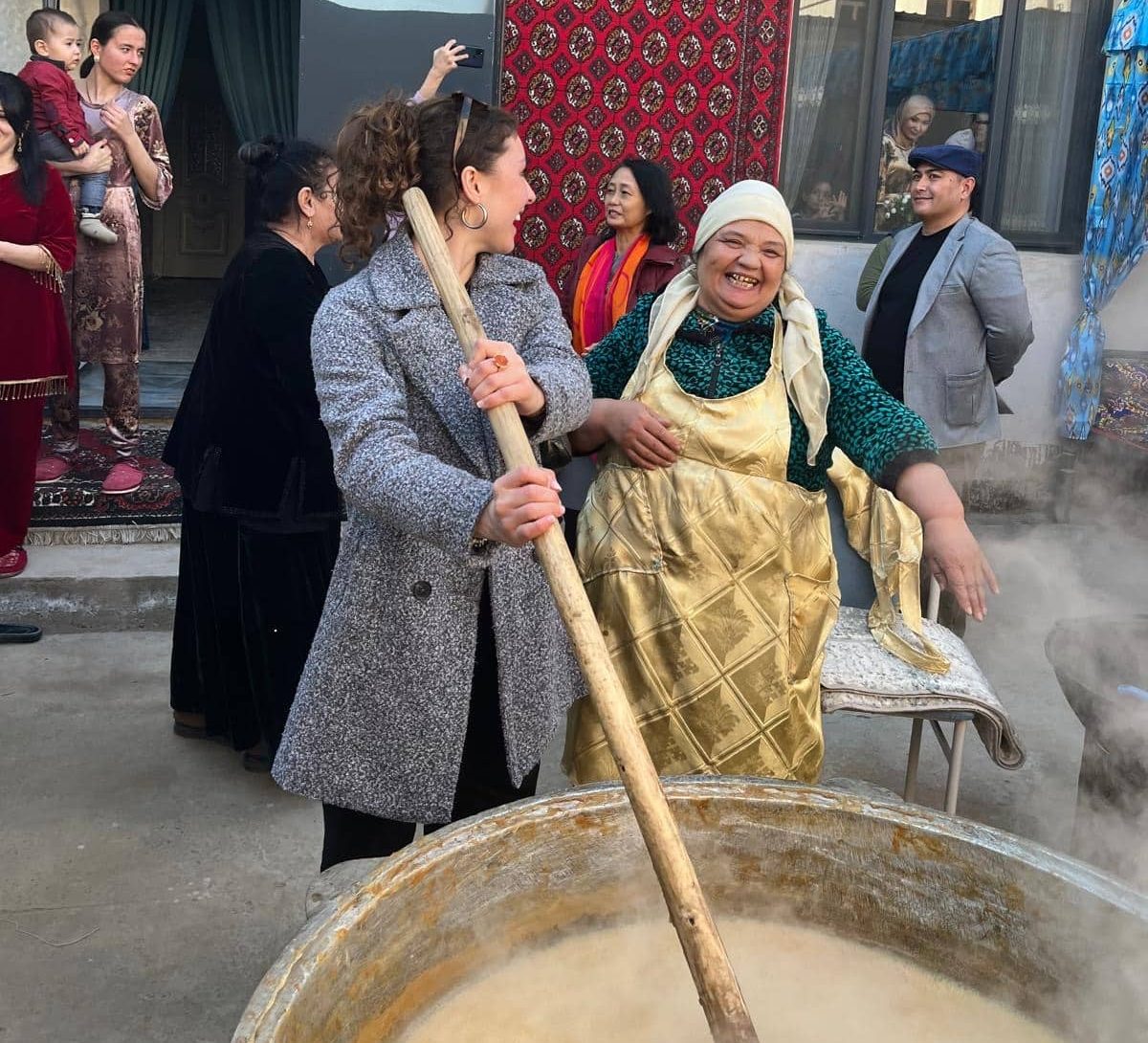 Helping to stir the sumalak, a labor-intensive festival food eaten only for Navruz.