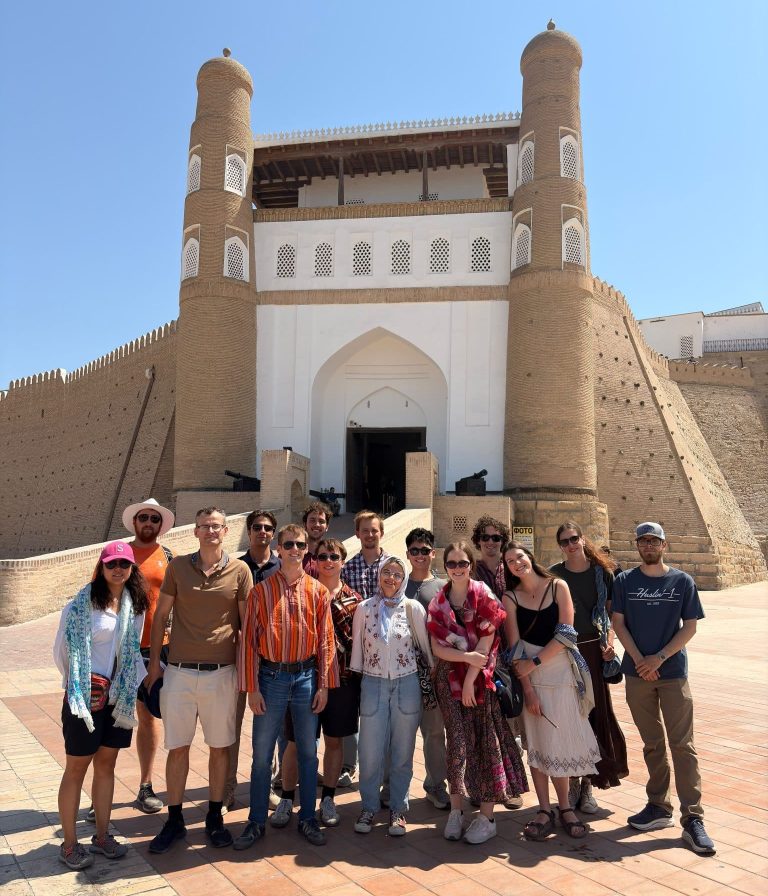A group of SRAS students posing in front of the monumental ceremonial gate of the Ark of Bukhara, an ancient and massive fortress located in Bukhara, Uzbekistan.