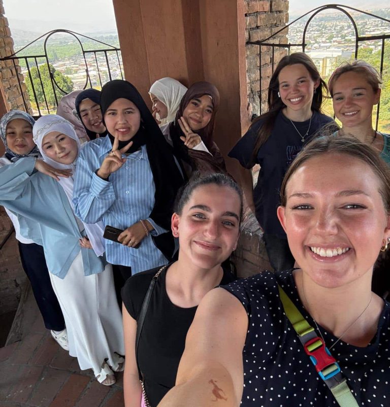 SRAS students shoot a selfie with locals the met while touring Central Asia.