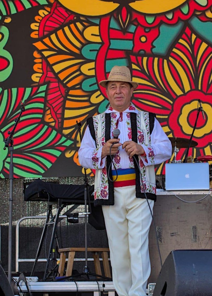 An artist in national costume performs at a free open festival.