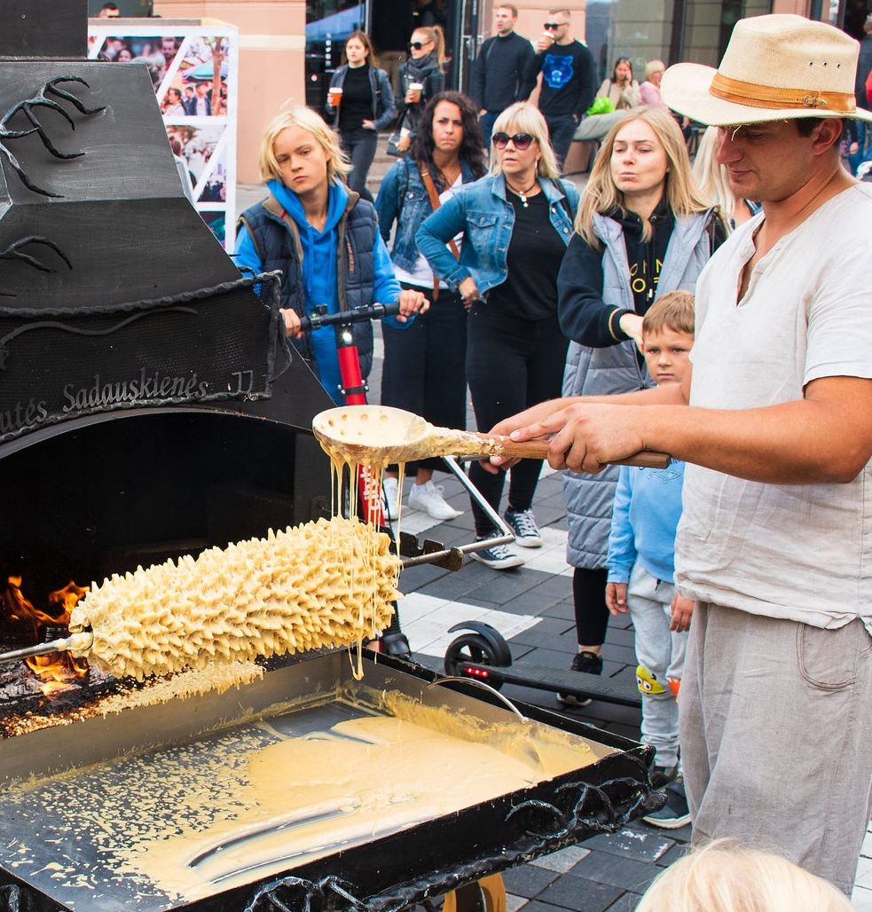 A street vendor makes a traditional šakotis cake in Lithuania.